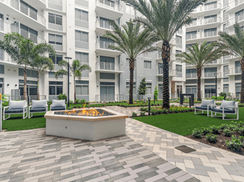Garden courtyard with water feature, fire pit and hammocks